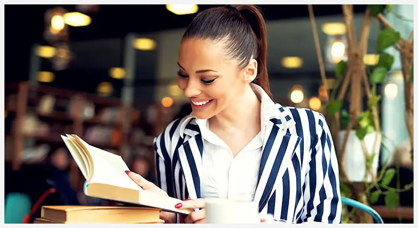 beautiful-young-student-preparing-her-english-exams-university-campus-using-laptop-handbook-education-concept